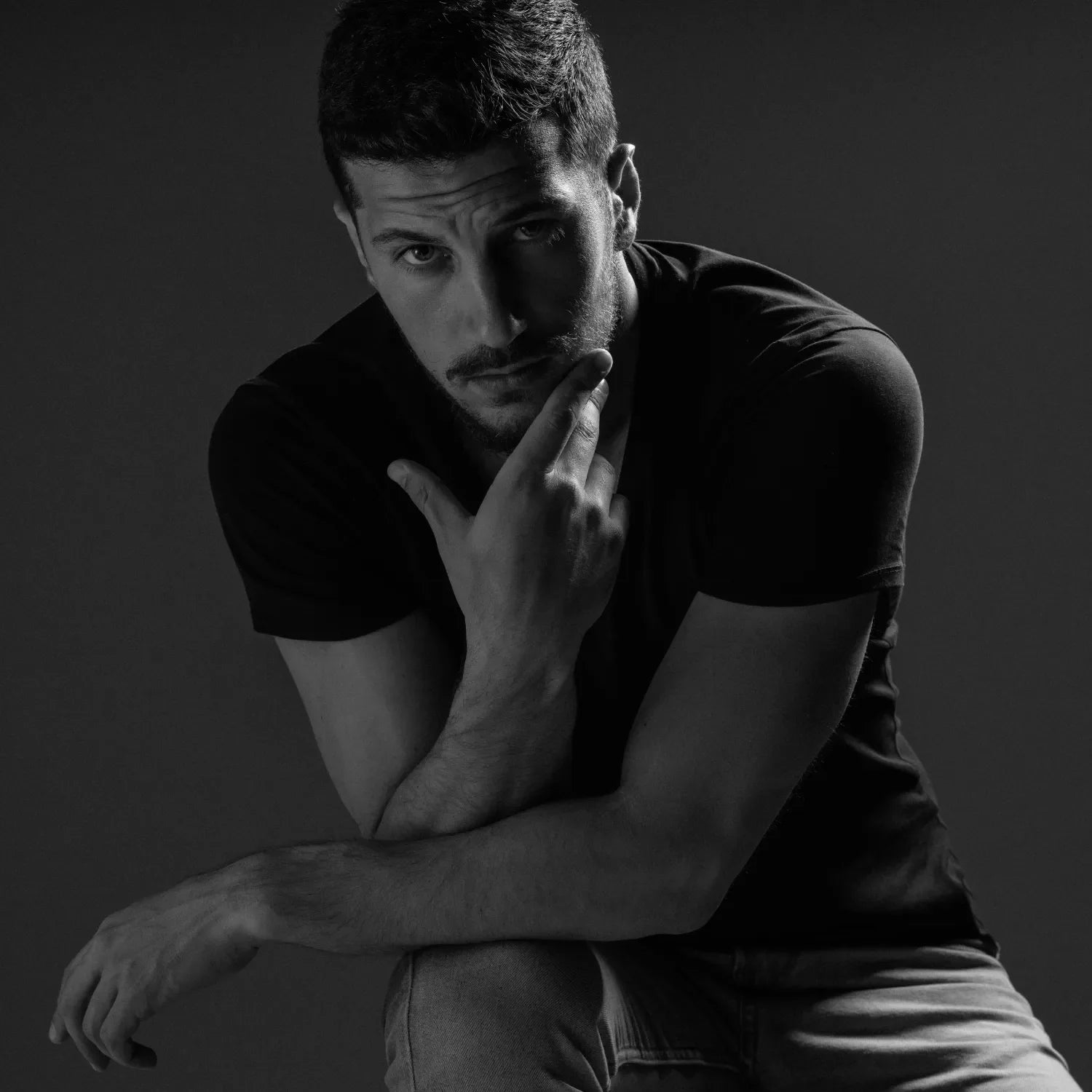 Man wearing black t-shirt and jeans from Basic Clothes Co. Men's Essentials collection