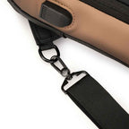 USB cable connected to the charging port of the Basic Clothes Co. crossbody bag, demonstrating on-the-go charging