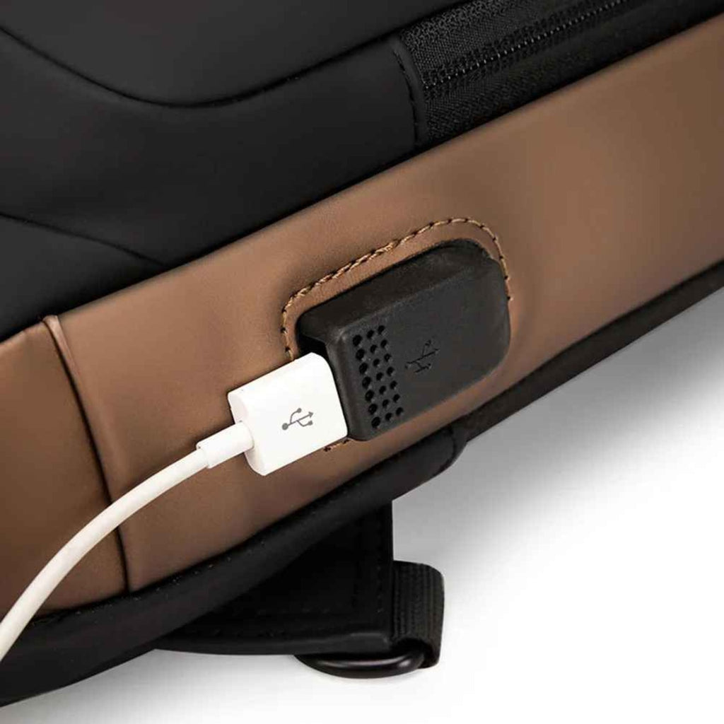 Close-up of the integrated external USB charging port on the side of the Basic Clothes Co. anti-theft bag.